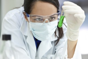 Female Laboratory Scientist or Doctor & Green Liquid Test Tube