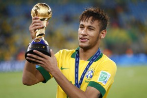 Brazil's Neymar celebrates with the trophy after winning their Confederations Cup final soccer match against Spain at the Estadio Maracana in Rio de Janeiro