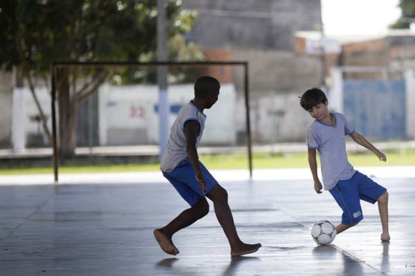 Gabriel Muniz, 11, plays soccer with schoolmates in Campos dos Goytacazes