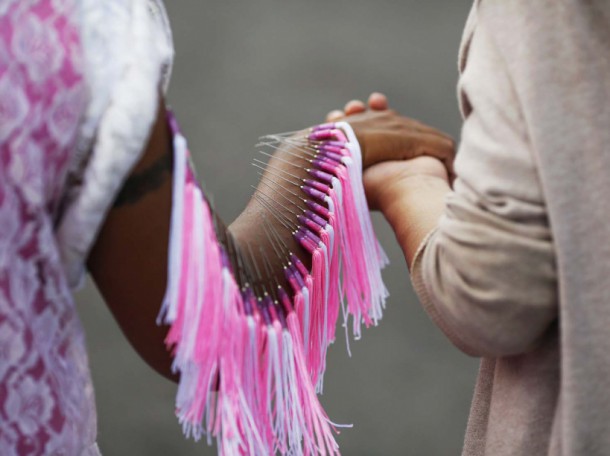 A devotee of the Ban Tha Rua Chinese shrine with needles pierced through her arm takes a part in a procession celebrating the annual vegetarian festival in Phuket