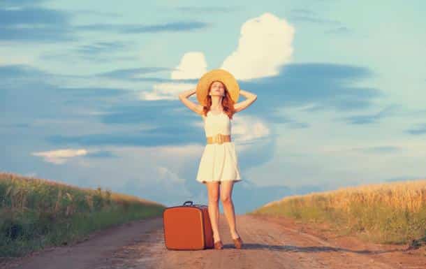 Redhead girl with suitcase at outdoor.
