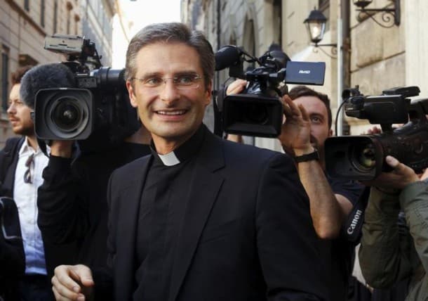 814121-monsignor-krzystof-charamsa-smiles-as-he-leaves-at-the-end-of-his-news-conference-in-downtown-rome