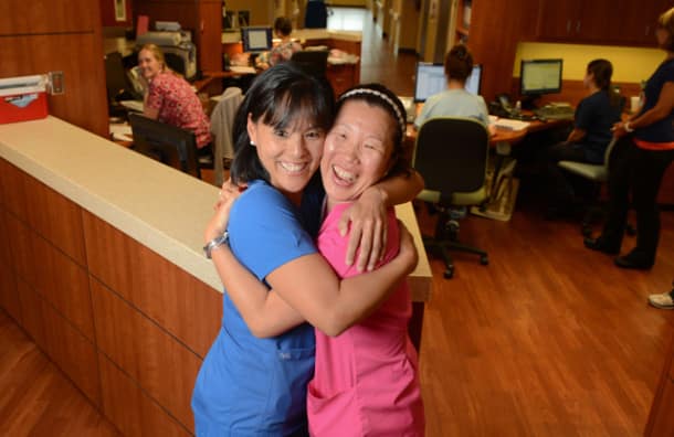 Adopted out of a Korean orphanage as children, sisters Meagan Hughes, left, and Holly Hoyle O'Brien found each other again while working on the same floor at Doctors Hospital of Sarasota. STAFF PHOTO / DAN WAGNER