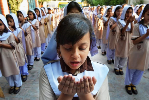 Pakistani school girls pray for the early recovery of child activist Malala Yousafzai, who was shot in the head in a Taliban assassination attempt, at their school in Peshawar on October 12, 2012. Pakistanis at mosques across the country prayed Friday for the recovery of a schoolgirl shot in the head by the Taliban as doctors said the next two days were critical. AFP PHOTO / A. MAJEED (Photo credit should read A. MAJEED/AFP/GettyImages)