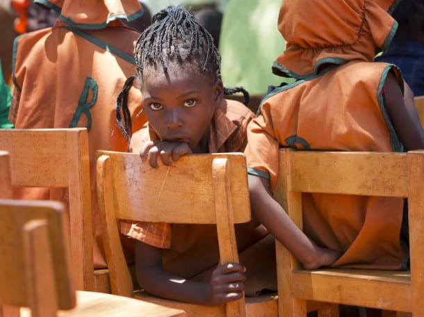 HARARE, ZIMBABWE - DECEMBER 03: A young schoolgirl looking bored during a concert at the Glen Forest Development Centre, which is funded by the relief organization Misereor funded and is situated in an area of the town badly affected by the governmental policy of dispossession and which has a very low rate of school enrolment on December 03, 2012 in Harare, Zimbabwe. (Photo by Raphael Huenerfauth/Photothek via Getty Images)