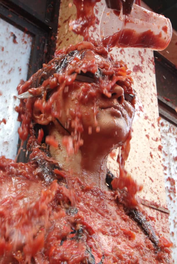 Tomatoes are poured over a reveler during the annual “Tomatina”, tomato fight fiesta, in the village of Bunol, 50 kilometers outside Valencia, Spain, Wednesday, August 31, 2016. The streets of an eastern Spanish town are awash with red pulp as thousands of people pelt each other with tomatoes in the annual “Tomatina” battle that has become a major tourist attraction. At the annual fiesta in Bunol on Wednesday, trucks dumped 160 tons of tomatoes for some 20,000 participants, many from abroad, to throw during the hour-long morning festivities. (Photo by Alberto Saiz/AP Photo)