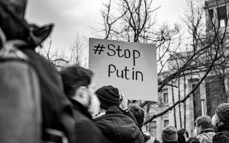 Black and white photo of a Berlin protest with a Stop Putin sign.