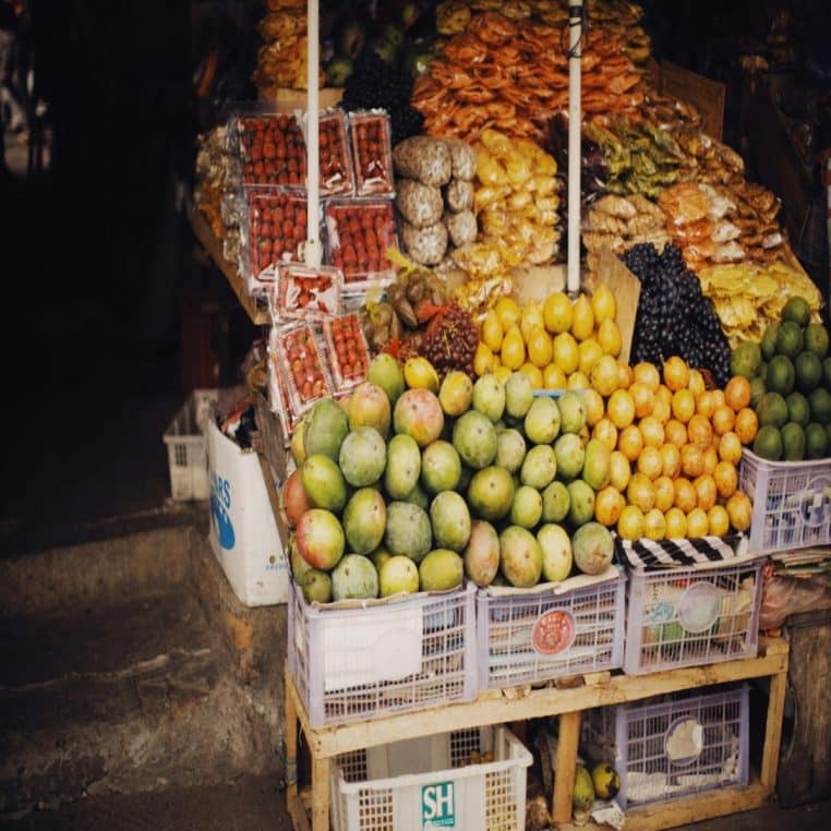Étal de marché rempli de melons et d’autres fruits colorés