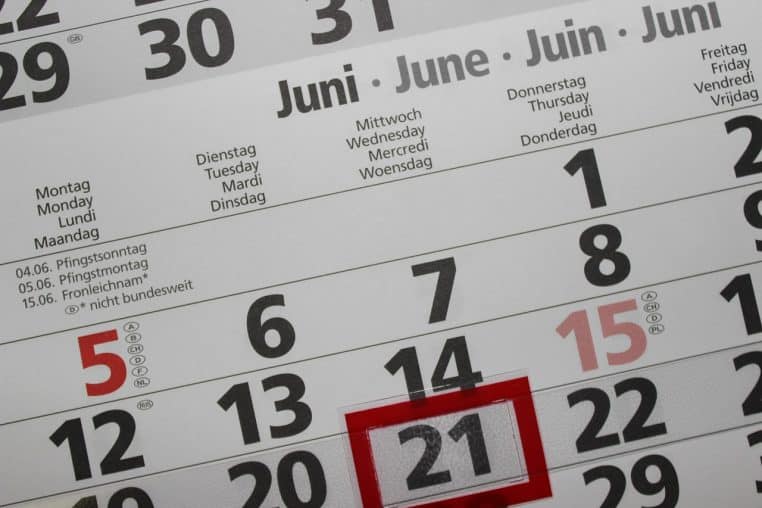 Gros plan sur un calendrier papier, journée soulignée en rouge.