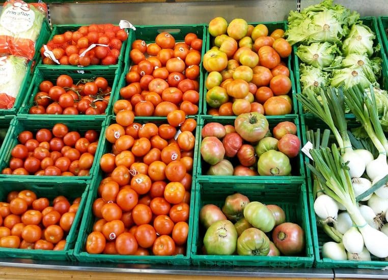 Caisses de tomates rouges dans un supermarché.