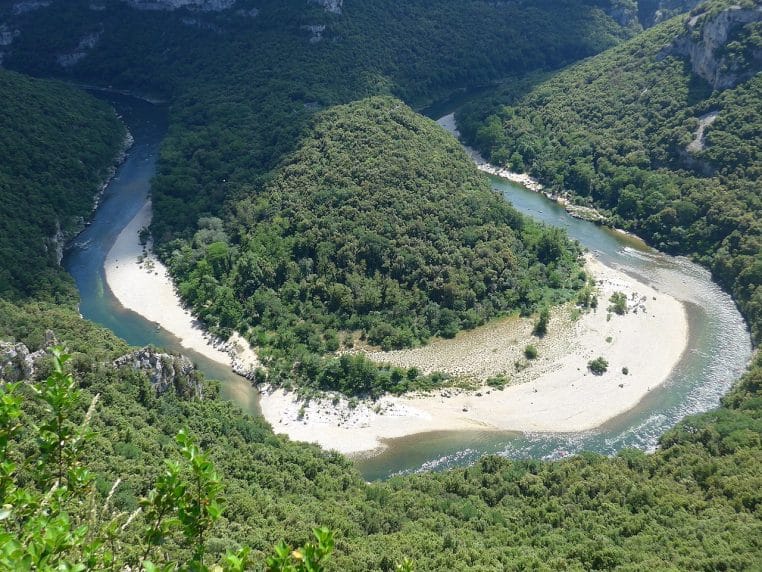 Route panoramique dominant les gorges de l’Ardèche sous un ciel clair.