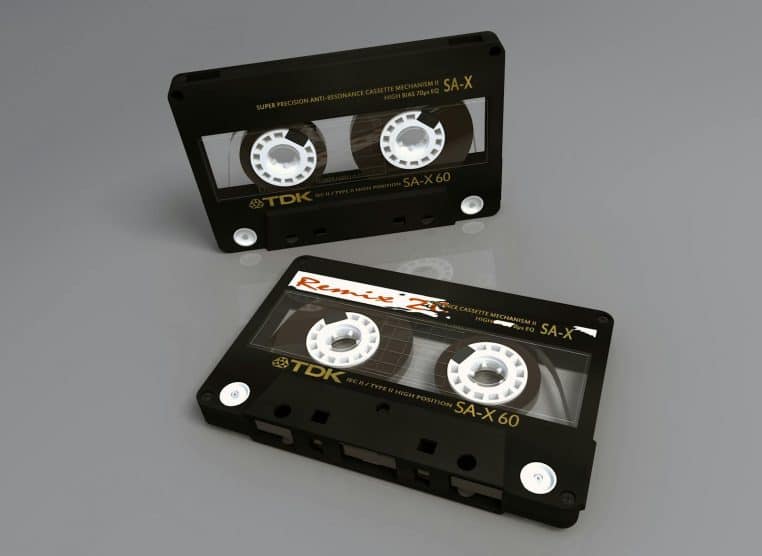 Two vintage TDK SA-X 60 cassette tapes showcasing retro audio technology on a reflective surface.