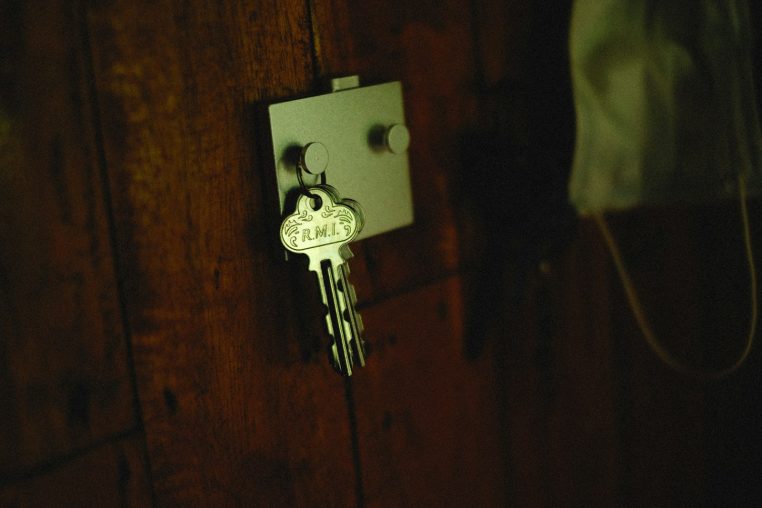 a key is attached to a wooden door