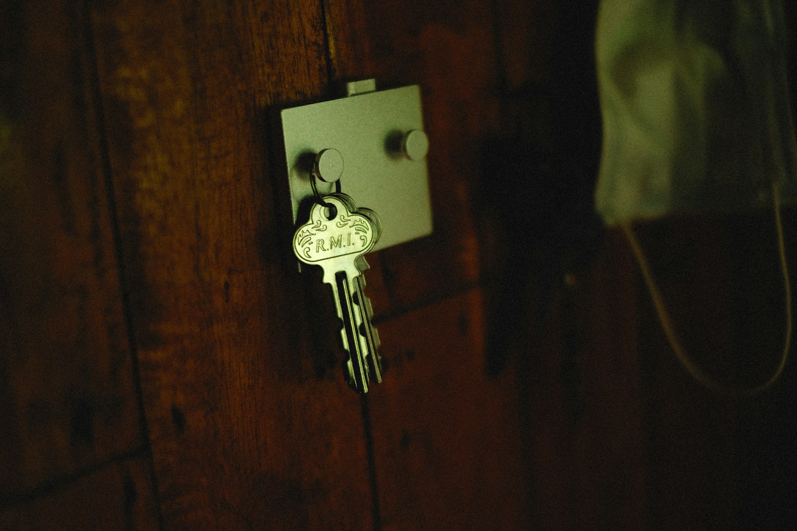 a key is attached to a wooden door