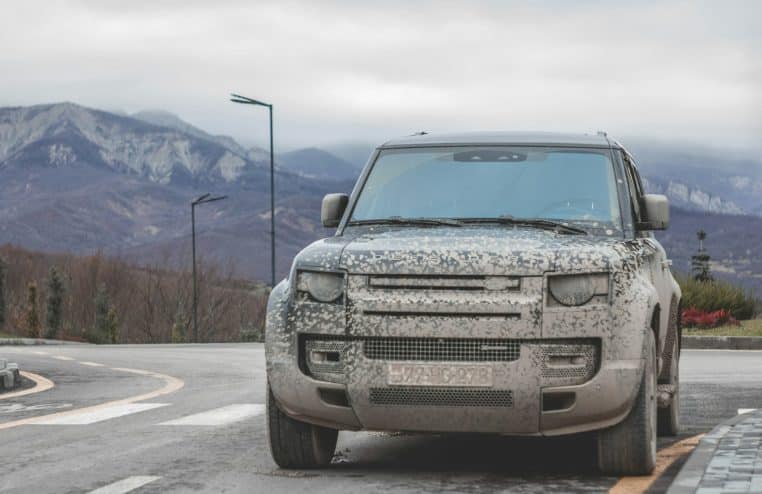 a silver truck parked on the side of a road