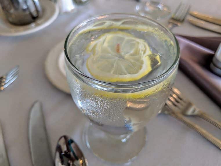 verre d’eau tiède au citron posé près d’une fenêtre