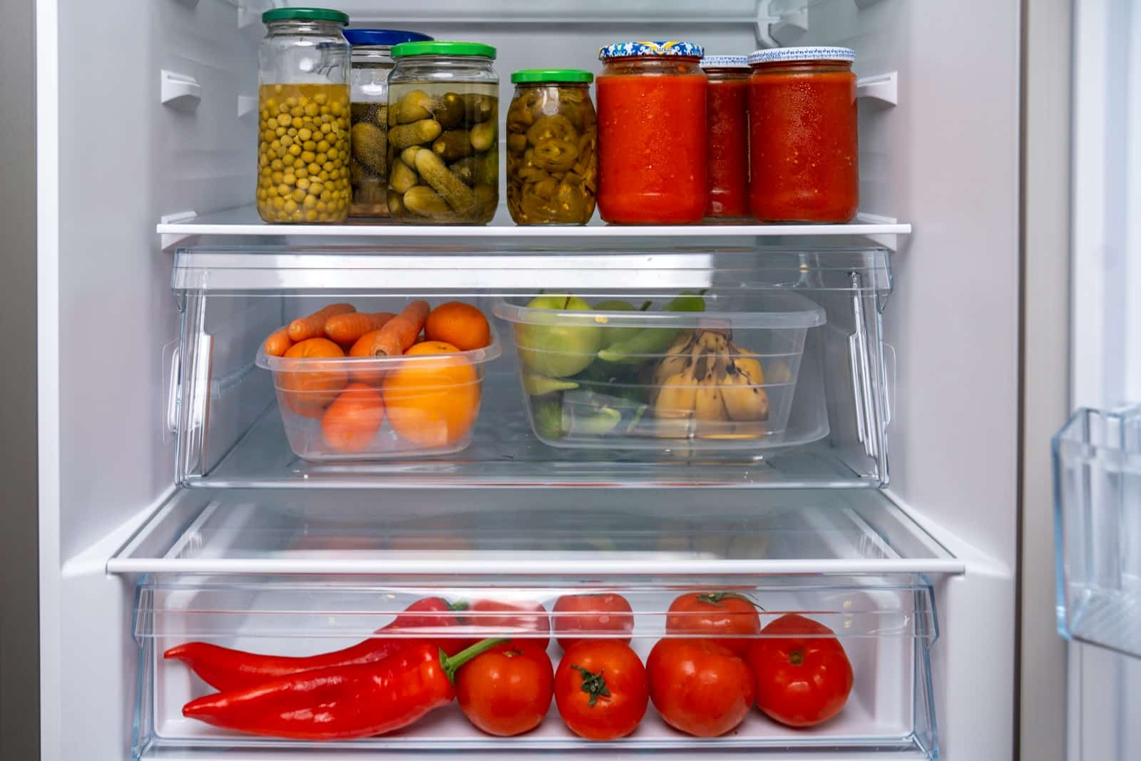 A refrigerator filled with lots of different types of food