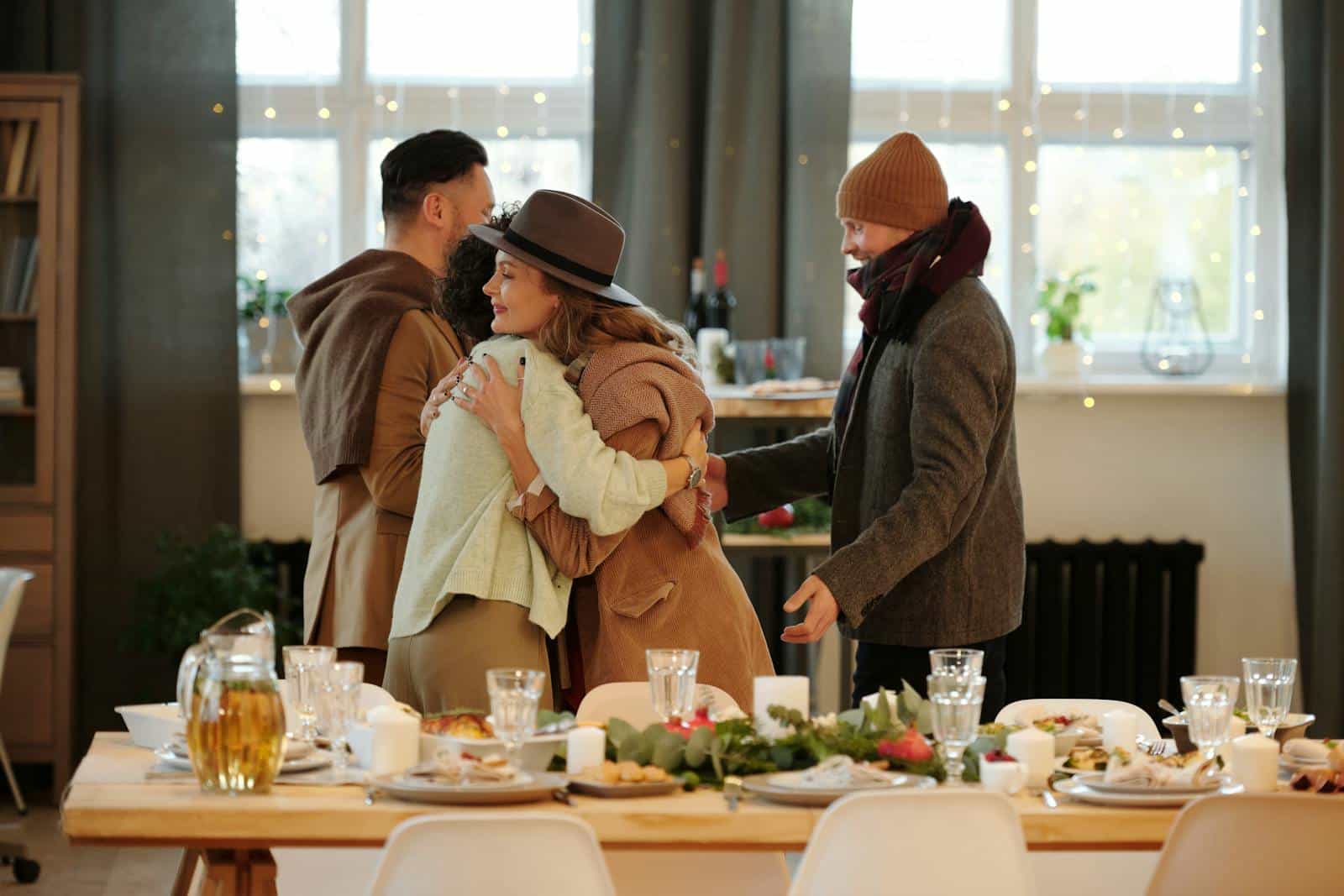 Family embracing and dining together indoors during festive holiday season.