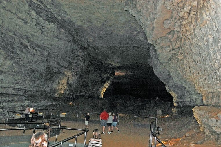 Touristes cheminant dans une vaste salle de Mammoth Cave, montrant l’échelle monumentale du réseau.