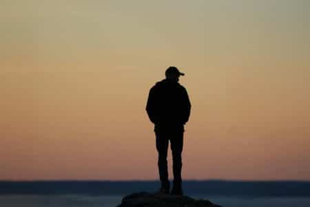 A lone silhouette of a person as the sky transitions from twilight to dawn in Stamford, Connecticut.