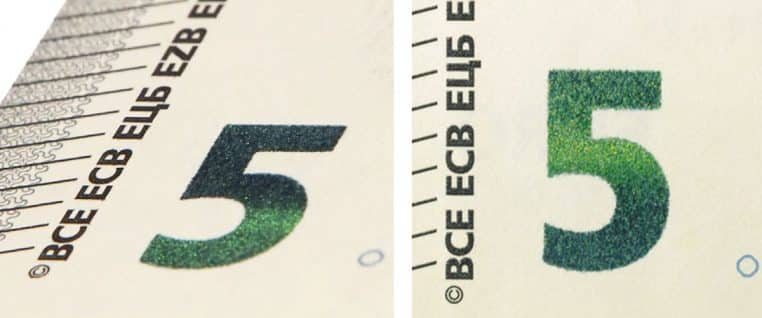 Gros plan sur le chiffre 5 émeraude d’un billet de 5 euros montrant la variation de couleur qui atteste de l’authenticité du billet