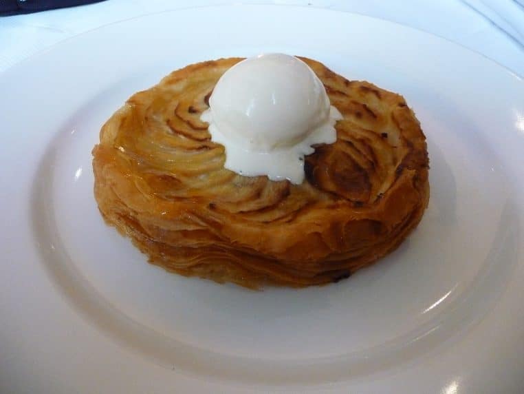 Tarte fine aux pommes individuelle, feuilletage croustillant et belle caramélisation, surmontée d’une boule de glace.