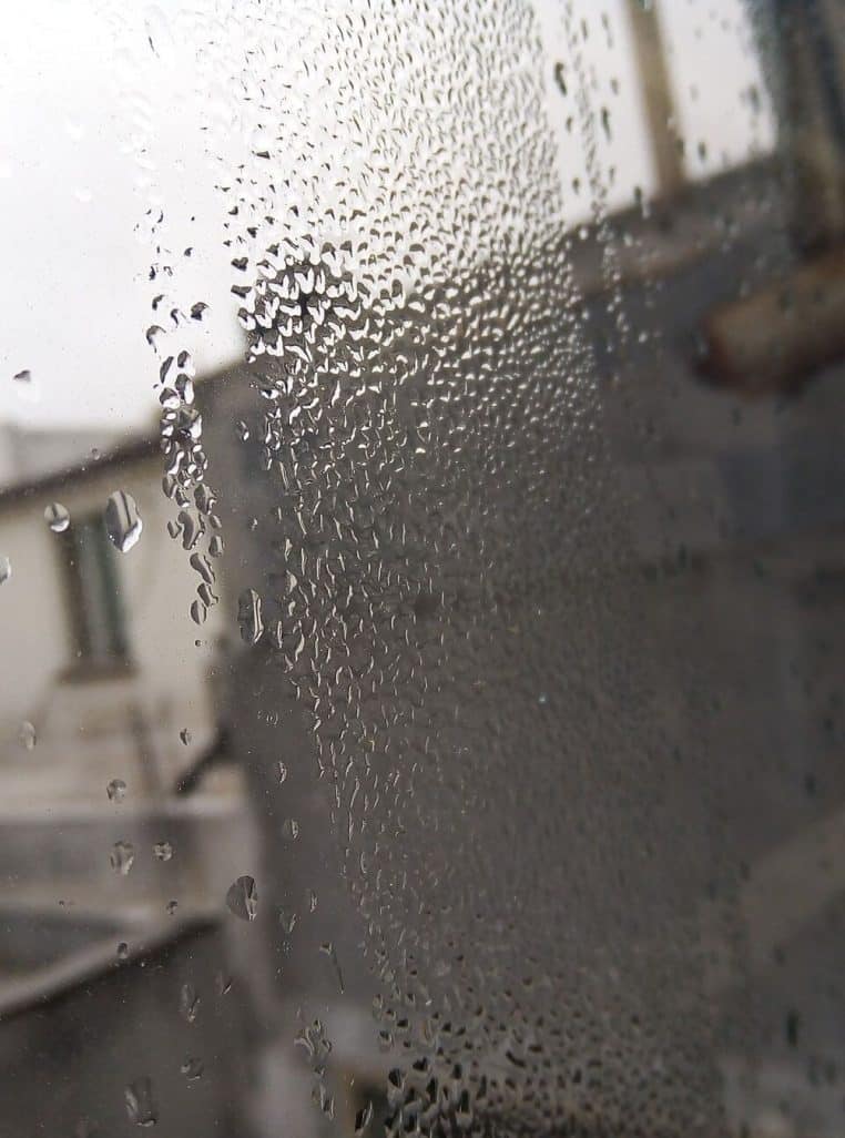 Gouttes de condensation sur vitre intérieure ; signe d’un air humide et d’une pièce insuffisamment chauffée ou ventilée.