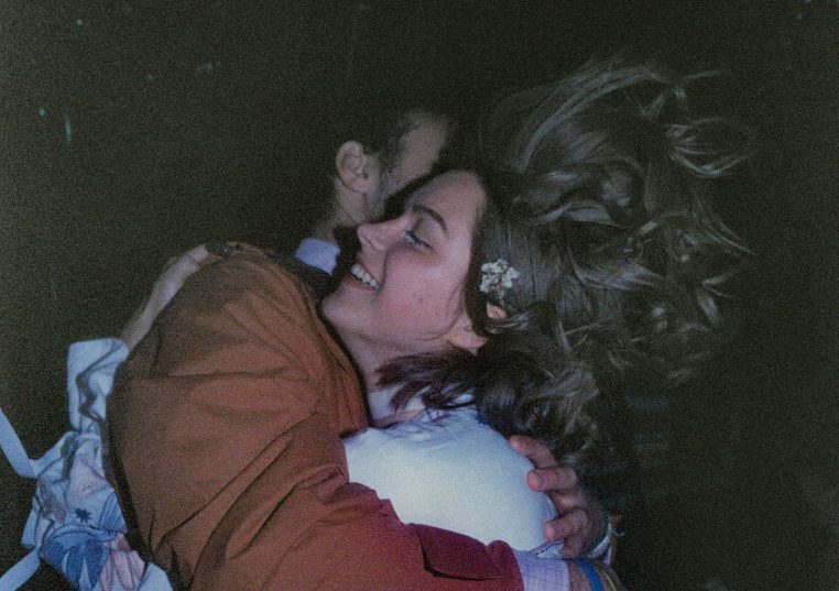 Couple embracing with hair blowing in the wind