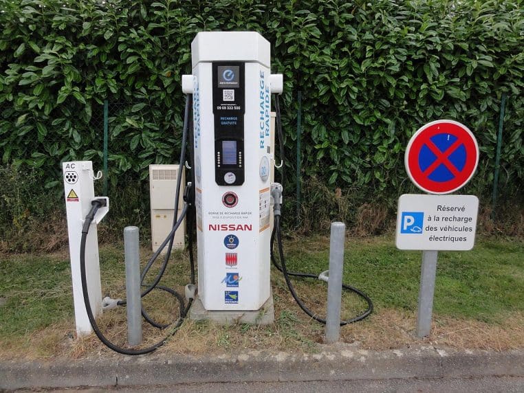Borne de recharge rapide pour véhicules électriques en Bretagne, avec signalisation dédiée et installation en bord de route.