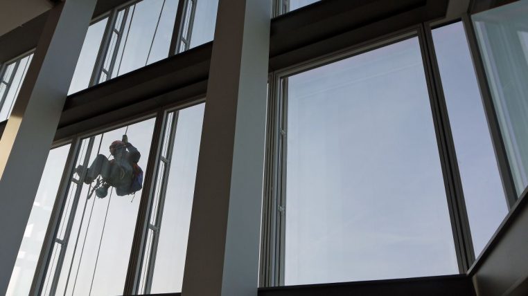 Nettoyeur de vitres en hauteur sur la façade du Shard à Londres, scène réelle de nettoyage sur grandes surfaces vitrées.