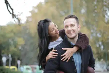 Joyful couple enjoying a romantic moment outdoors in a city park.