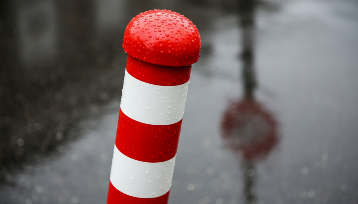 Gros plan sur les rayures rouges et blanches d'un poteau d'arrêt de bus
