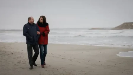 Un couple se promène sur une plage venteuse en hiver dans la série Un si grand soleil