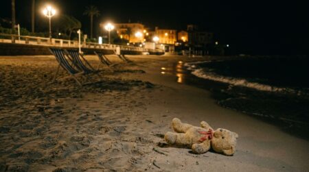 Peluche abandonnée sur le sable d'une plage de nuit
