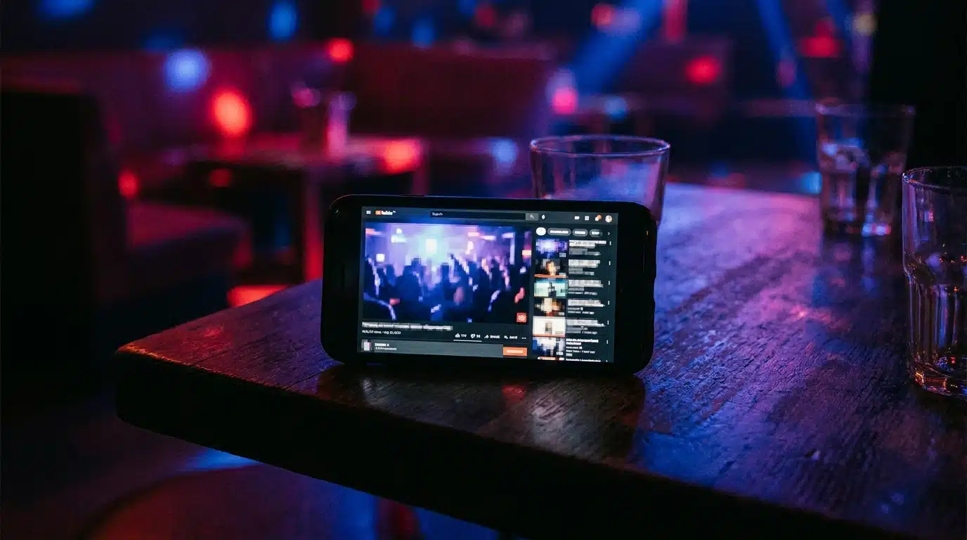 Smartphone posé sur un comptoir affichant une vidéo floue de boîte de nuit
