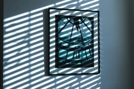 a shadow of a clock on a wall