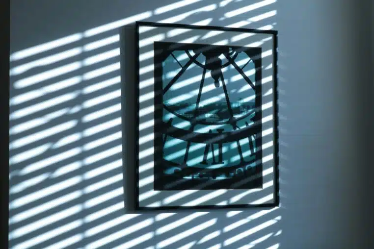 a shadow of a clock on a wall